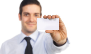 portrait of businessman showing blank card
