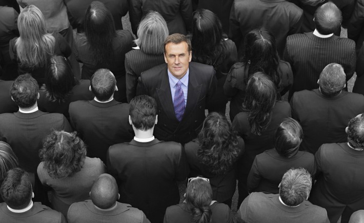 High angle view of a businessman standing amidst businesspeople